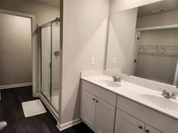 a bathroom with a double vanity sink and mirror