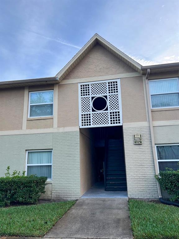 9817 Turf Way, Unit GE Orlando, FL 32837 - Photo 1 of 19 a front view of house with yard