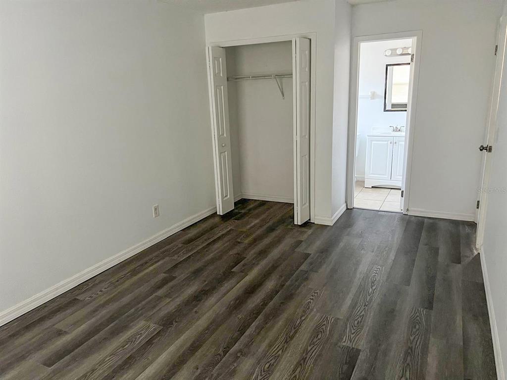 9817 Turf Way, Unit GE Orlando, FL 32837 - Photo 15 of 19 a view of a room with wooden floor and closet