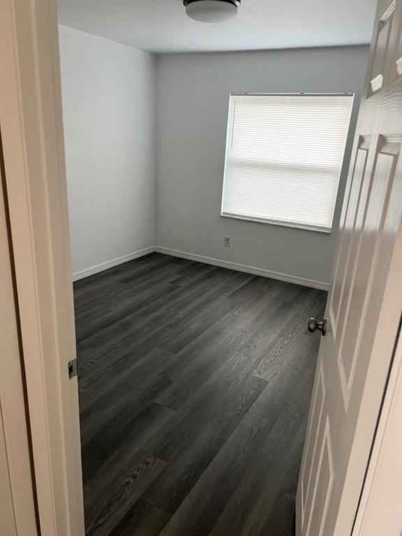 9817 Turf Way, Unit GE Orlando, FL 32837 - Photo 16 of 19 a view of an empty room with wooden floor and a window