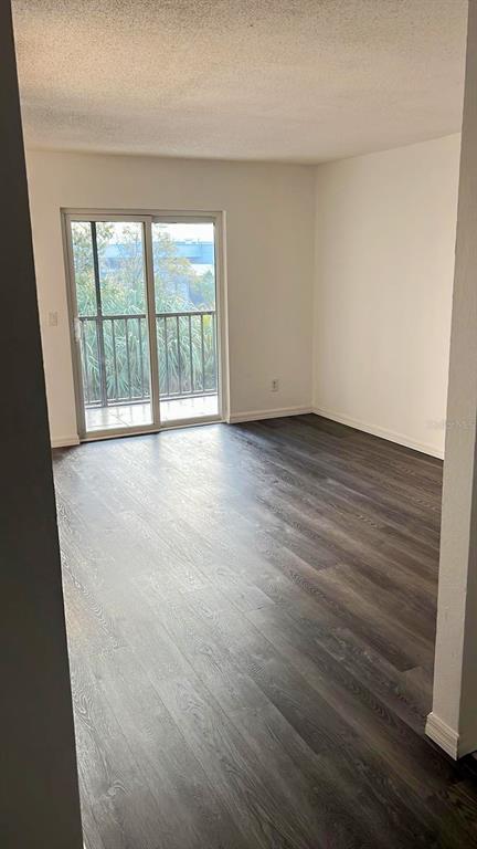 9817 Turf Way, Unit GE Orlando, FL 32837 - Photo 17 of 19 a view of an empty room with wooden floor and a window