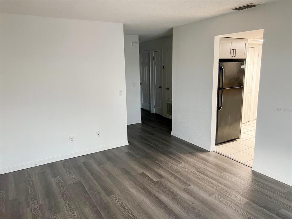 9817 Turf Way, Unit GE Orlando, FL 32837 - Photo 8 of 19 a view of an empty room with wooden floor and closet