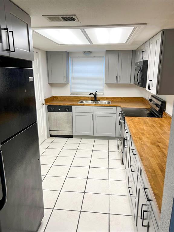 9817 Turf Way, Unit GE Orlando, FL 32837 - Photo 9 of 19 a kitchen with stainless steel appliances a stove a sink and a refrigerator