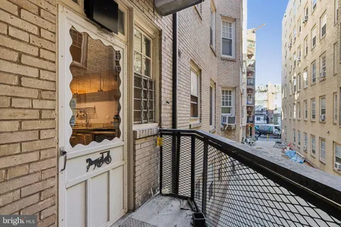 a view of a balcony with wooden floor and fence