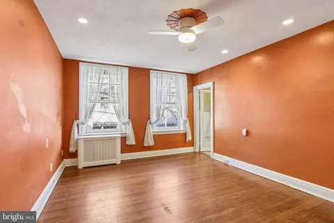 a view of a livingroom with wooden floor and a window