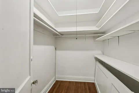 a view of walk in closet with empty racks