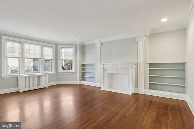 a view of wooden floor and windows in a room