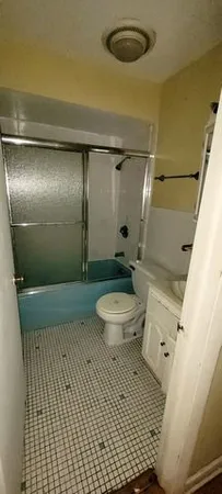 a bathroom with a toilet and a shower