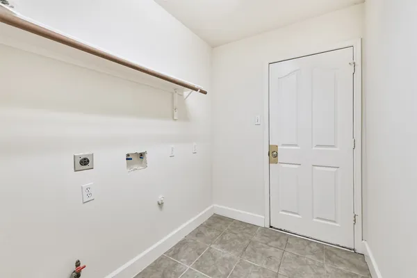 an empty room with a ceiling fan and carpet