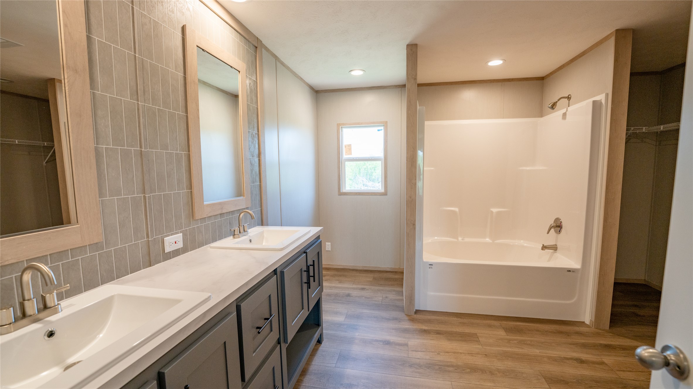1145 Callihan Road Luling, TX 78648 - Photo 31 of 39 a bathroom with a double vanity sink a mirror and a bathtub
