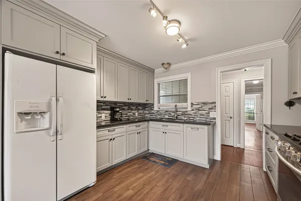 a kitchen with stainless steel appliances a sink stove and refrigerator