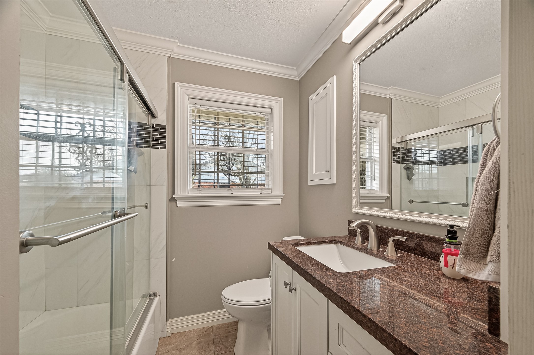 7702 Rockhill Street Houston, TX 77061 - Photo 14 of 30 a bathroom with a granite countertop sink toilet and a mirror