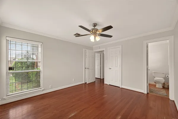 a view of a livingroom with wooden floor and a ceiling fan