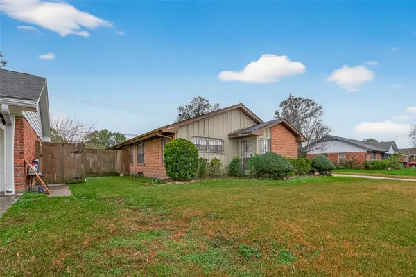 a view of a house with a yard and porch