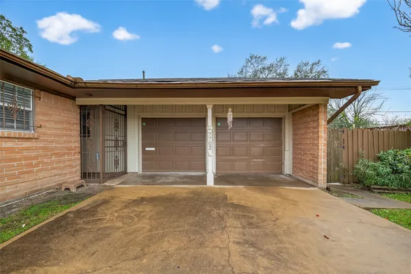 a view of house with backyard and garage