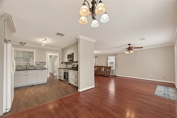 a view of a kitchen with a sink hardwood floor and a kitchen