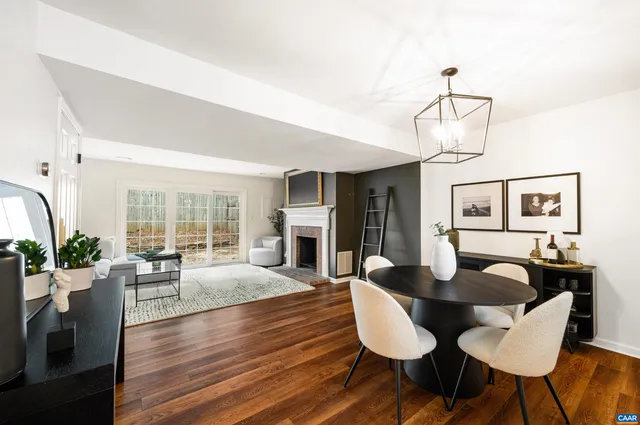 a view of a dining room with furniture wooden floor and chandelier