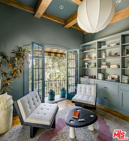 a bedroom with a bed large window and a fireplace