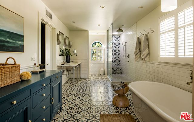 a bedroom with a bed table and a window