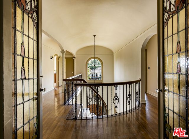 a spacious bedroom with a bed and a window