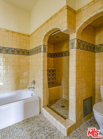 a bathroom with a shower and a sink