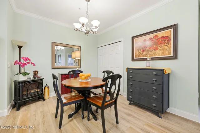 a view of a dining room with furniture and chandelier