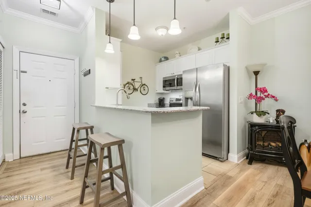 a kitchen with kitchen island a counter top space appliances and cabinets