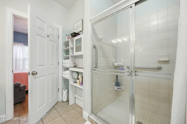 a bathroom with a glass shower door