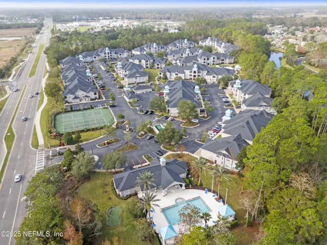 an aerial view of a house with a yard and sitting space