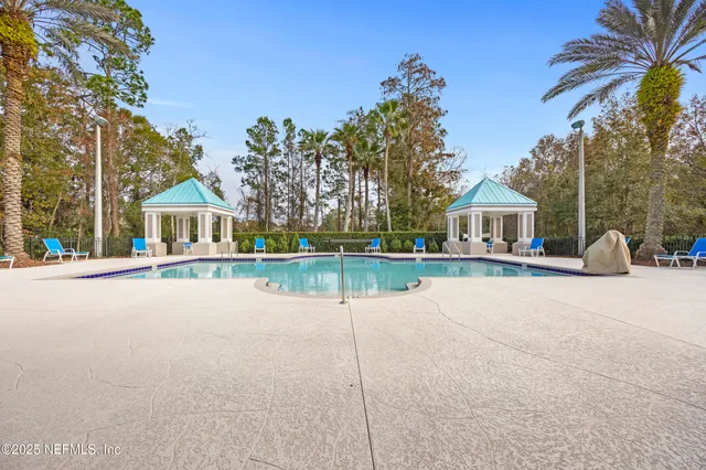 a view of house with outdoor space and swimming pool