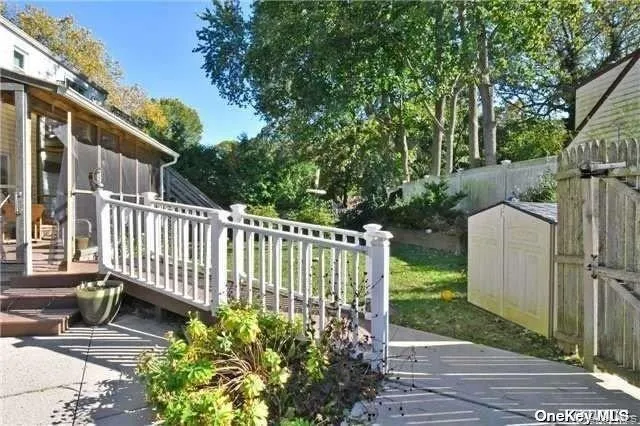 a view of a house with a yard and wooden fence