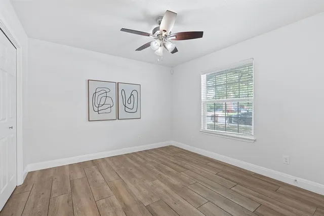 wooden floor in an empty room with a window
