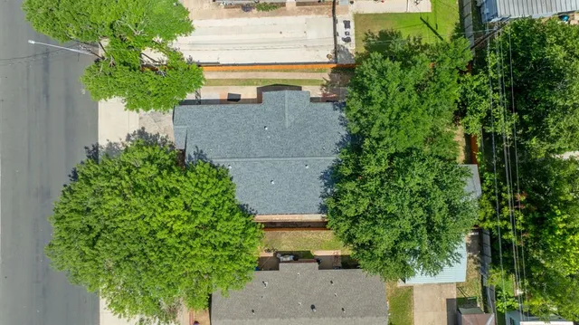 an aerial view of a house with a yard