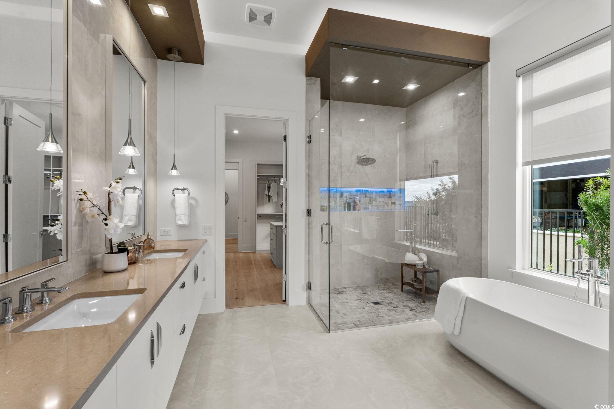 9273 Venezia Circle Myrtle Beach, SC 29579 - Photo 24 of 40 Bathroom with double vanity, a freestanding bath, a stall shower, and recessed lighting