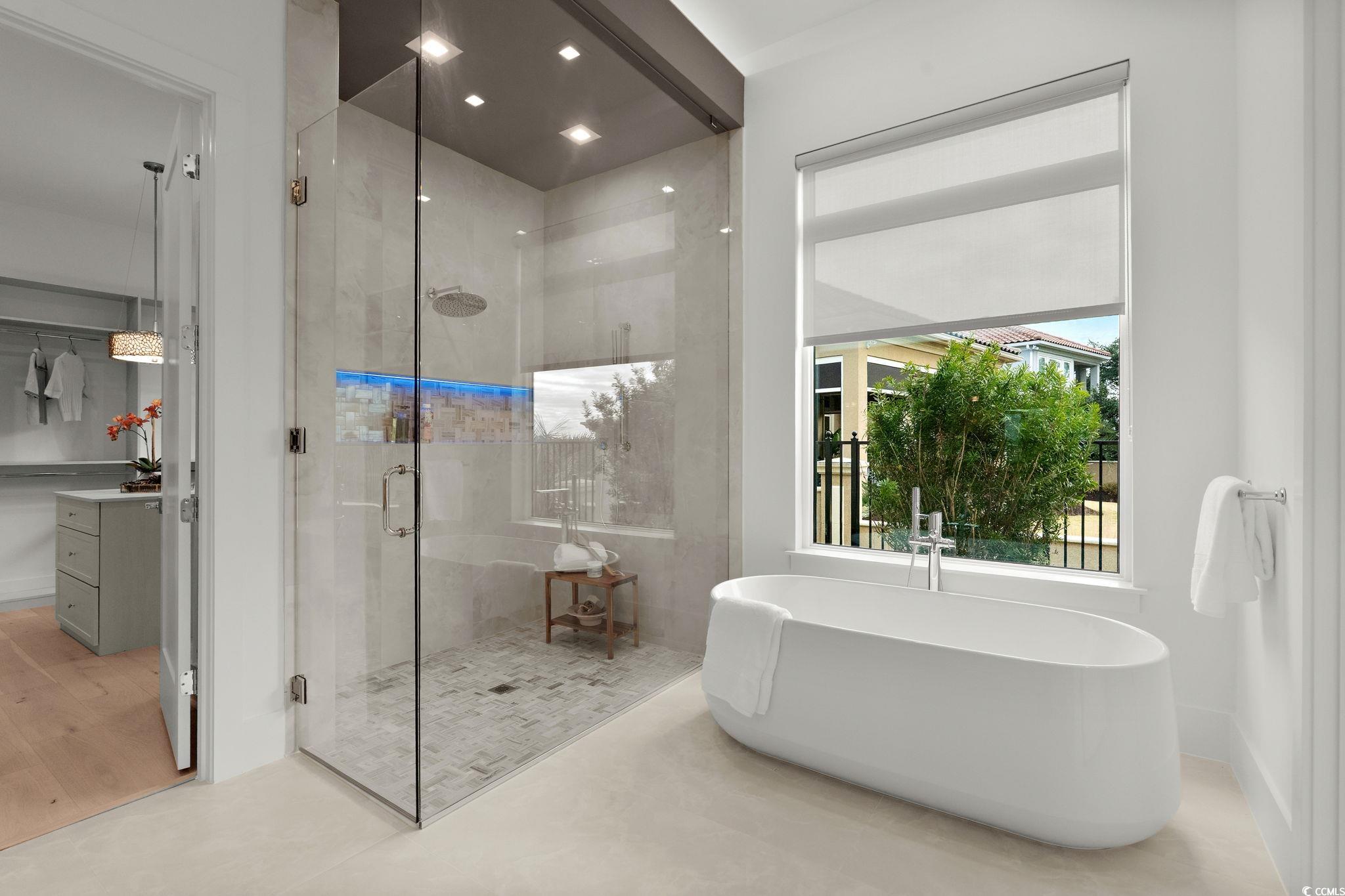 9273 Venezia Circle Myrtle Beach, SC 29579 - Photo 25 of 40 Bathroom with a stall shower, a freestanding bath, and a walk in closet