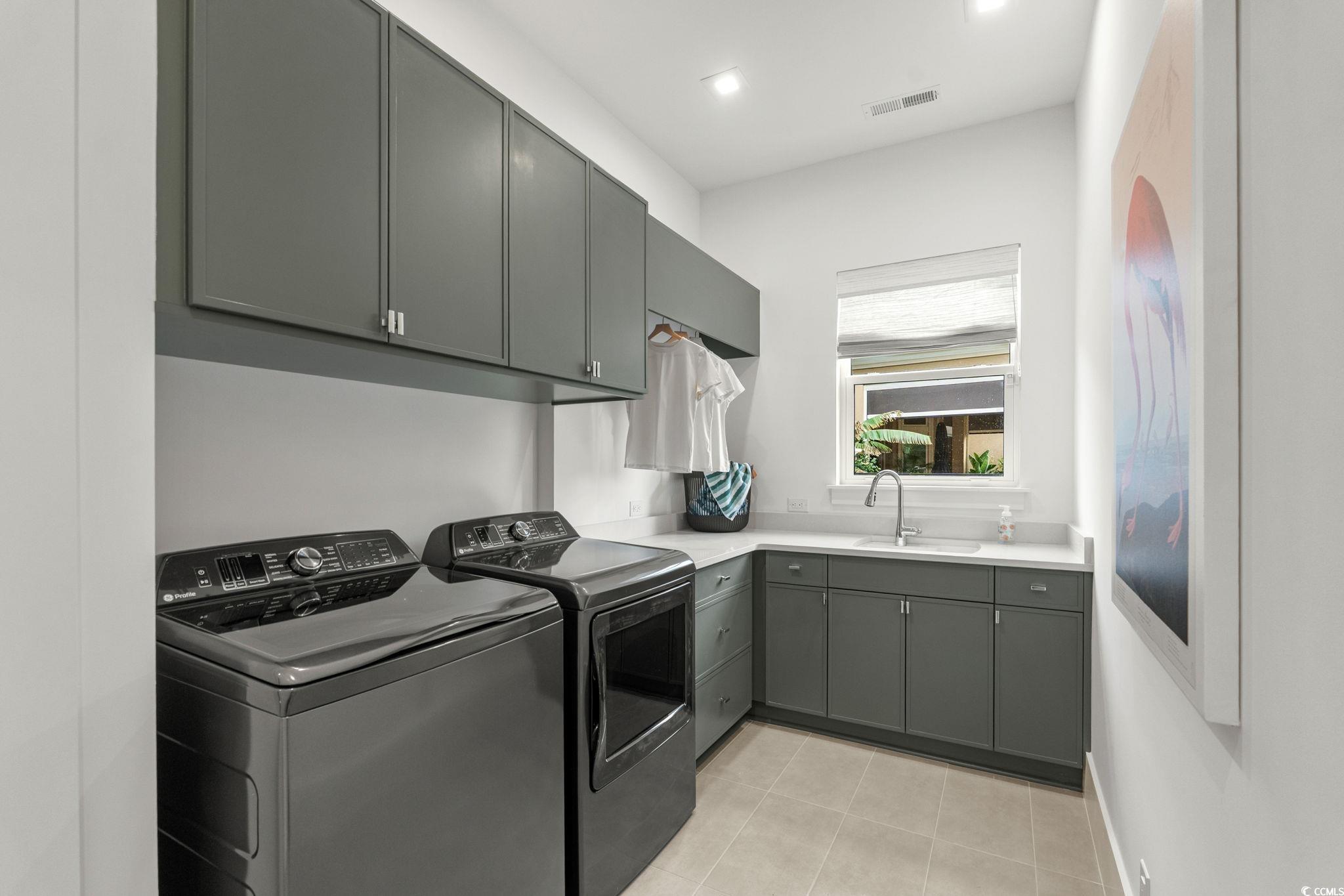 9273 Venezia Circle Myrtle Beach, SC 29579 - Photo 31 of 40 Laundry area featuring washing machine and clothes dryer, cabinet space, and recessed lighting
