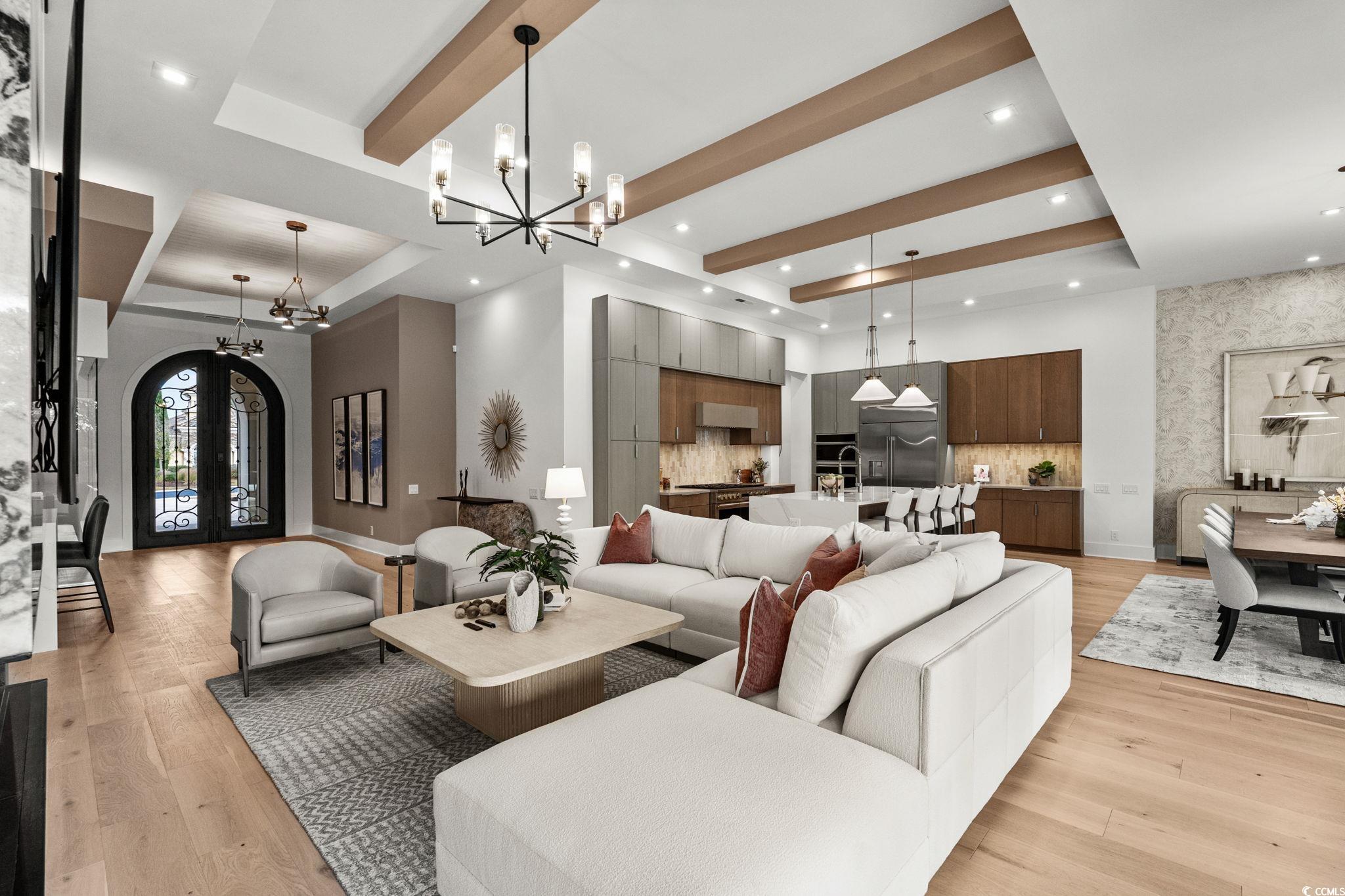 9273 Venezia Circle Myrtle Beach, SC 29579 - Photo 10 of 40 Living area featuring light wood-style flooring, a chandelier, french doors, arched walkways, and beam ceiling