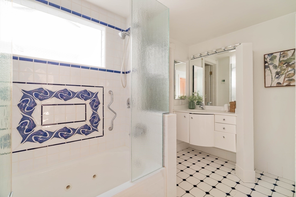 169 Commonwealth Avenue, Unit 5 Boston, MA 02116 - Photo 14 of 31 a bathroom with a sink a mirror and a shower