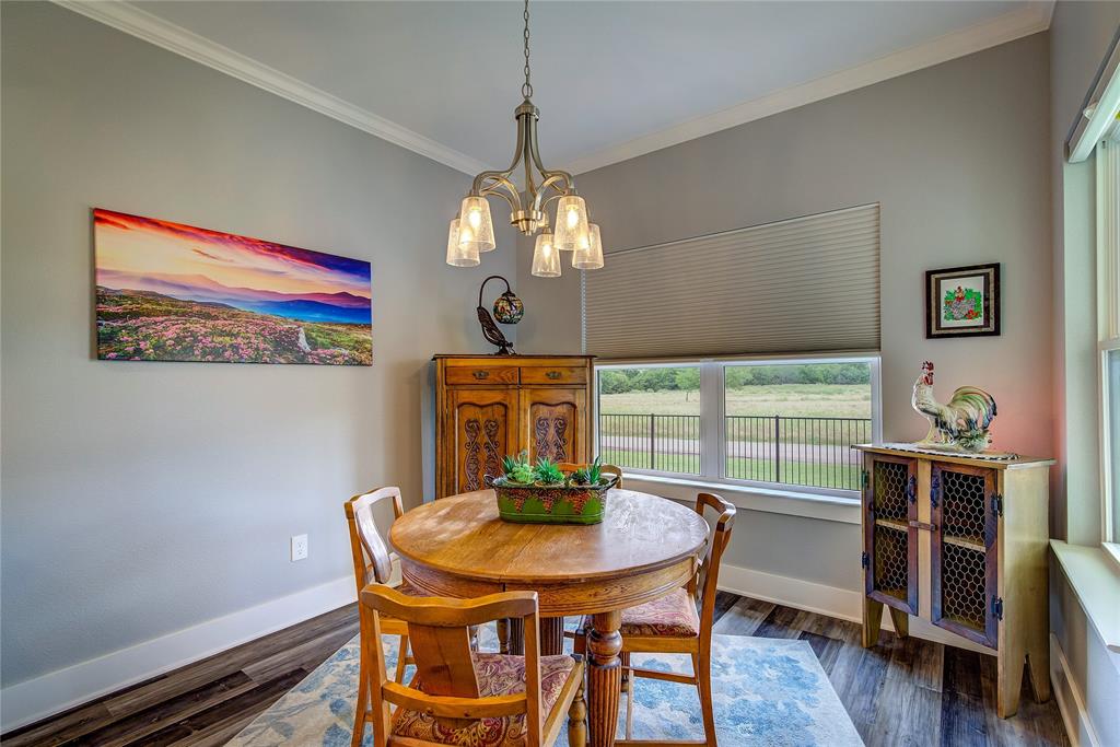 326 Koby Circle Sulphur Springs, TX 75482 - Photo 13 of 38 Dining area has windows on two sides for natural light, one-touch shades, crown molding.