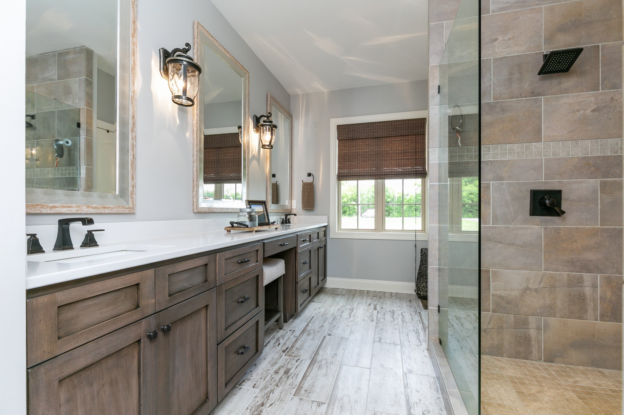 676 Burford Road Lebanon, TN 37087 - Photo 22 of 33 a bathroom with a double vanity sink a mirror and a bathtub