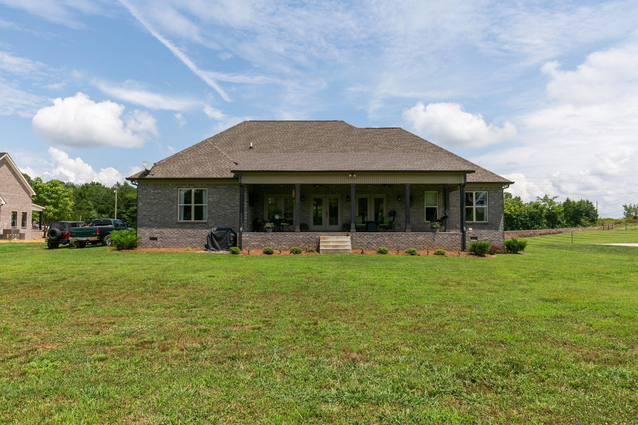 676 Burford Road Lebanon, TN 37087 - Photo 32 of 33 a front view of a house with a garden and porch