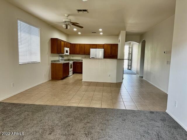 4311 South Splendor Place Gilbert, AZ 85297 - Photo 12 of 24 a view of kitchen with cabinets microwave and stove