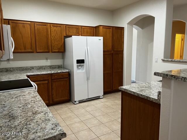 4311 South Splendor Place Gilbert, AZ 85297 - Photo 14 of 24 a kitchen with stainless steel appliances granite countertop a refrigerator sink and stove