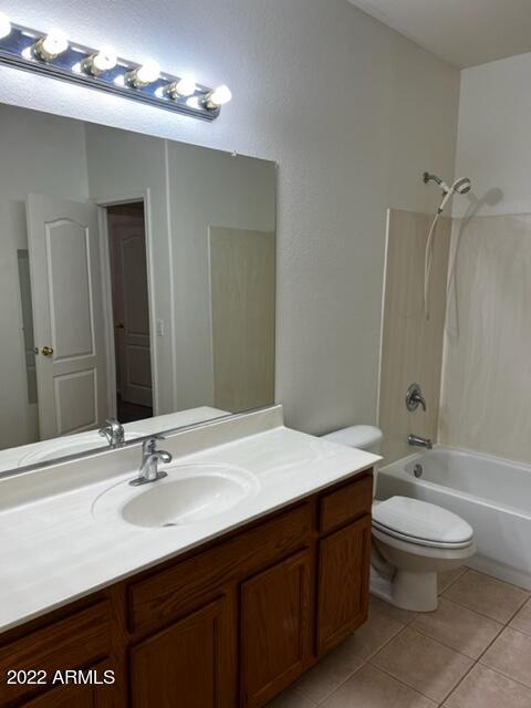 4311 South Splendor Place Gilbert, AZ 85297 - Photo 17 of 24 a bathroom with a double vanity sink toilet and a mirror