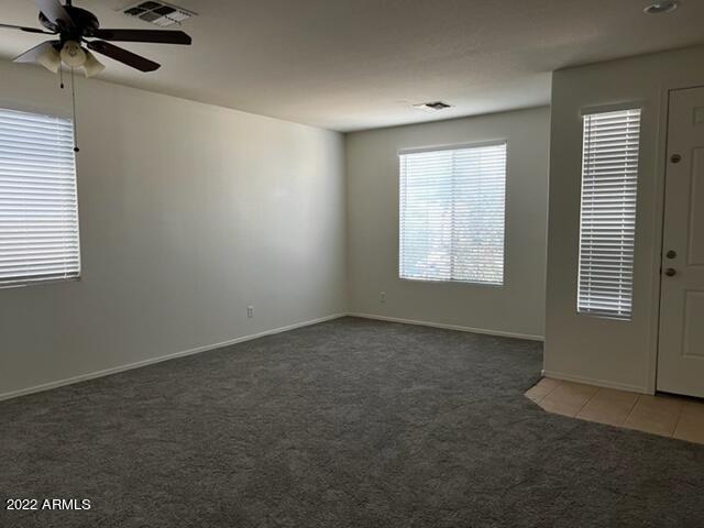 4311 South Splendor Place Gilbert, AZ 85297 - Photo 5 of 24 an empty room with a window and a fan