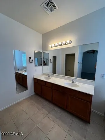 a large bathroom with a double vanity sink and a mirror