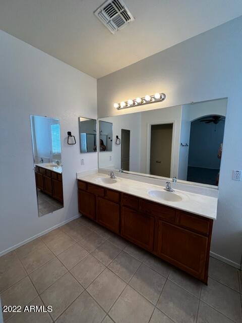 4311 South Splendor Place Gilbert, AZ 85297 - Photo 7 of 24 a large bathroom with a double vanity sink and a mirror