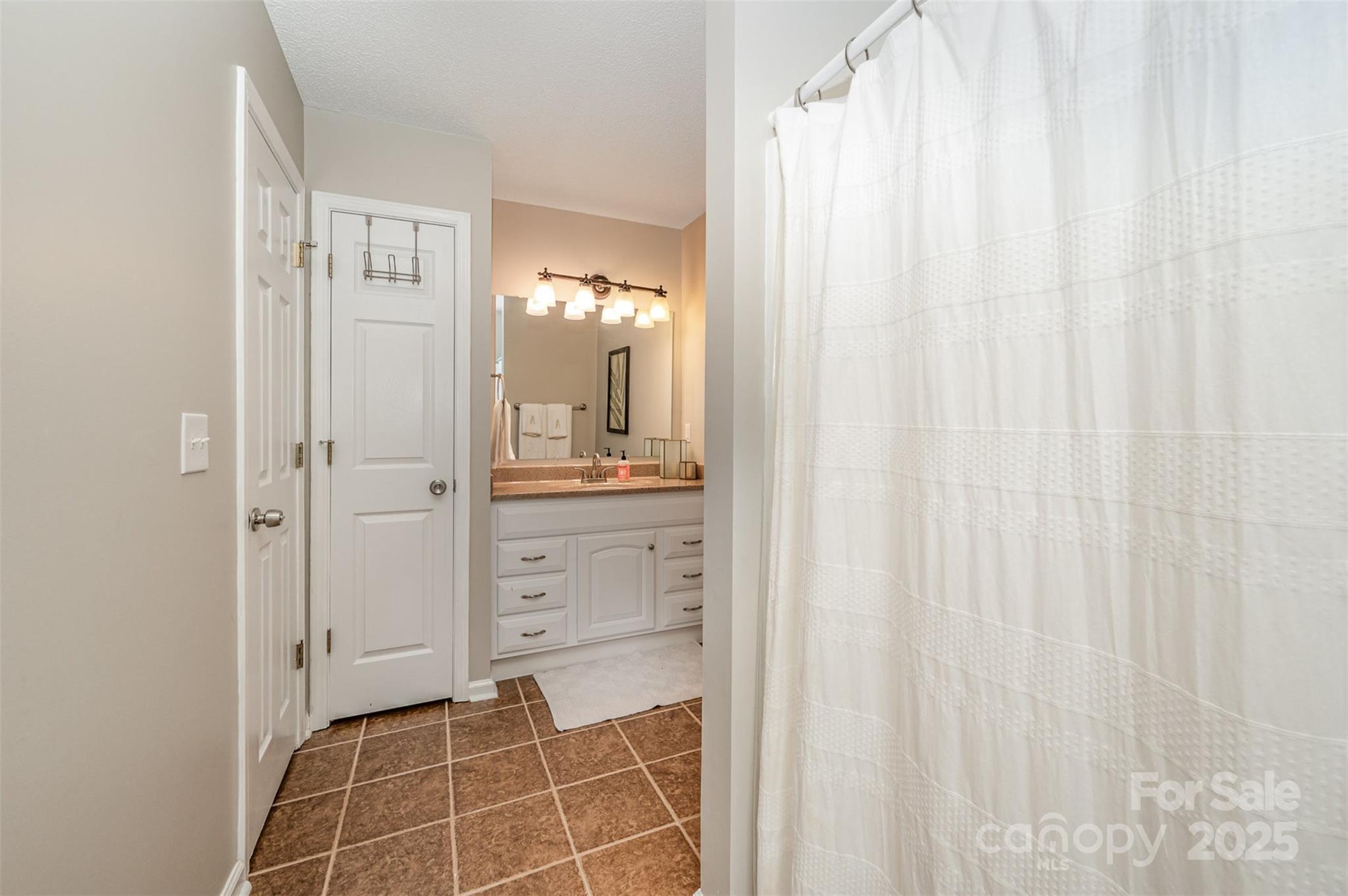 105 Banksridge Road Fort Mill, SC 29715 - Photo 17 of 30 a bathroom with a shower curtain and a window
