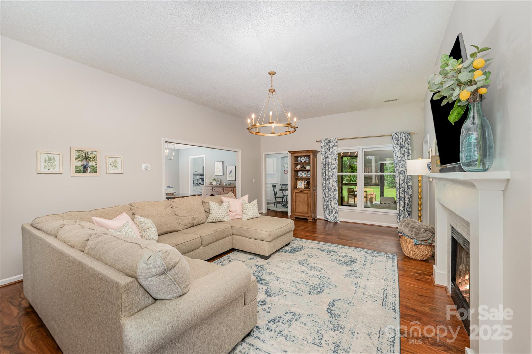 105 Banksridge Road Fort Mill, SC 29715 - Photo 3 of 30 a living room with furniture a fireplace and a chandelier