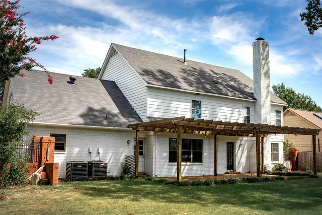 a front view of a house with a garden and plants